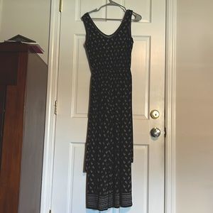 Black jumpsuit with white design. Used but in good condition with no label.